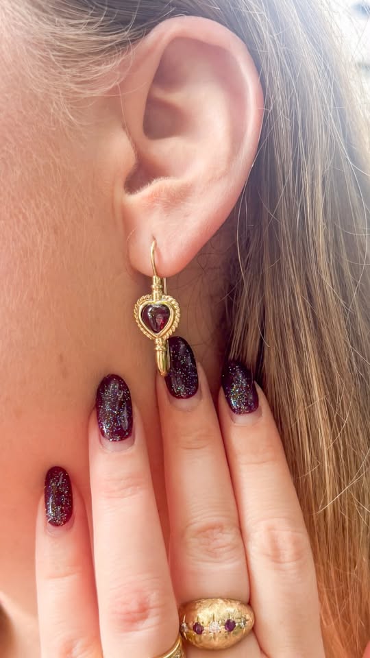 Vintage 9K earrings with bezel set cut rhodolite Garnet hearts.