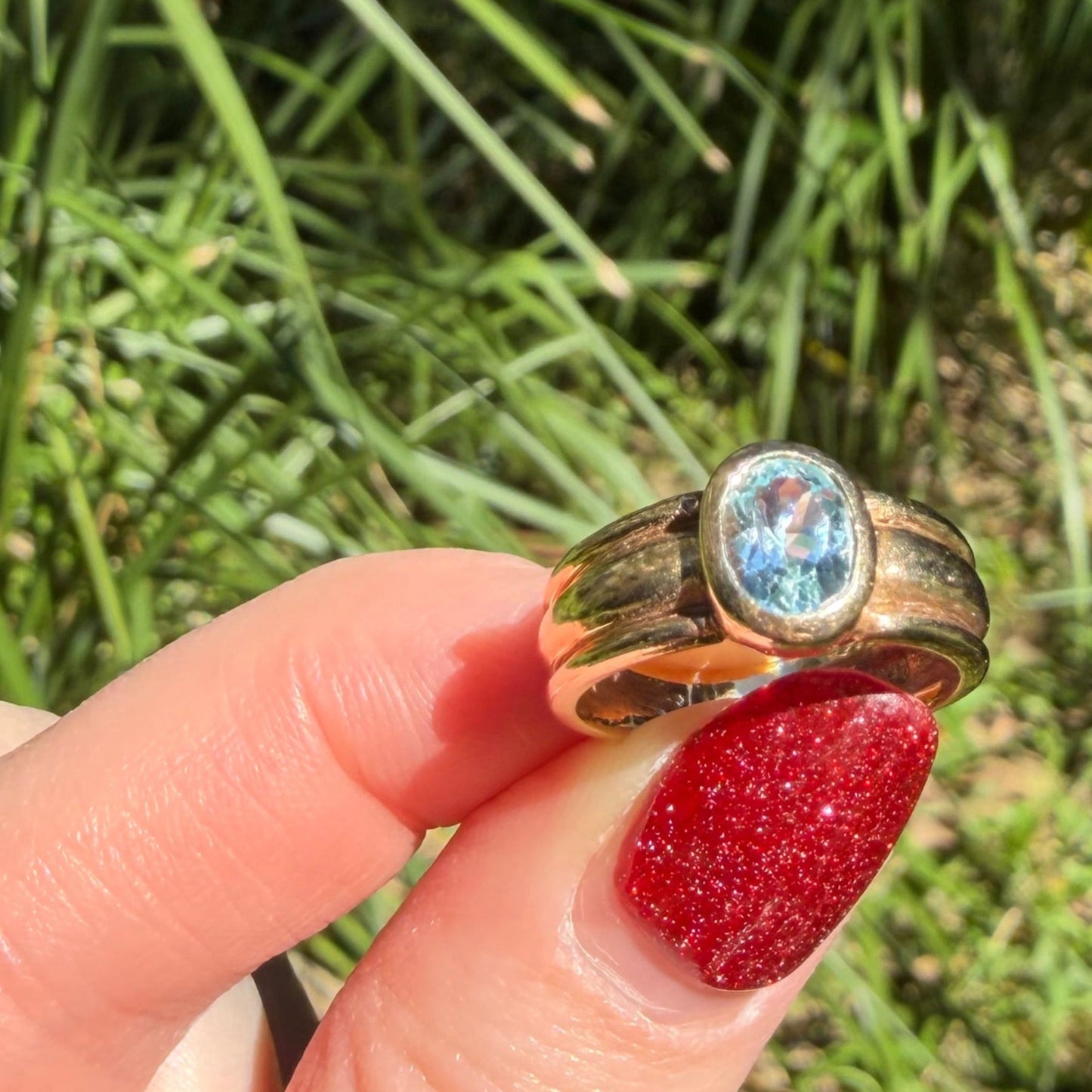Vintage 9CT ribbed ring bezel set with an oval cut Blue Topaz