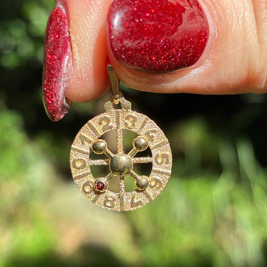 Vintage working 9CT roulette wheel charm with Garnet